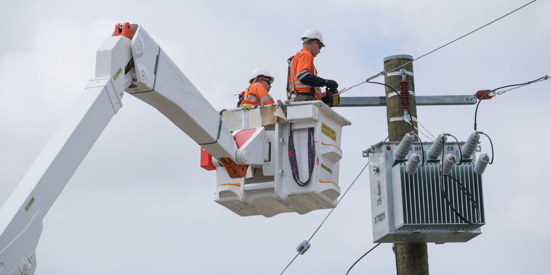 Western Power crew replacing a transformer that's attached to a pole