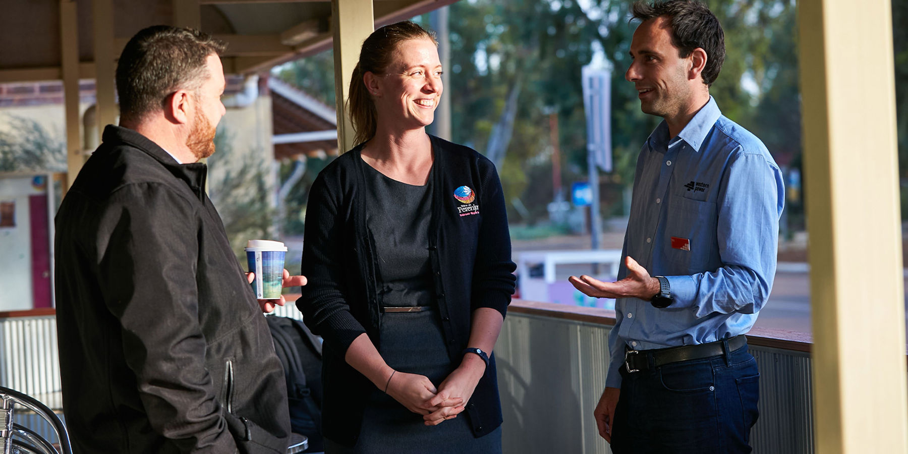 A Western Power employee talking to members of the community