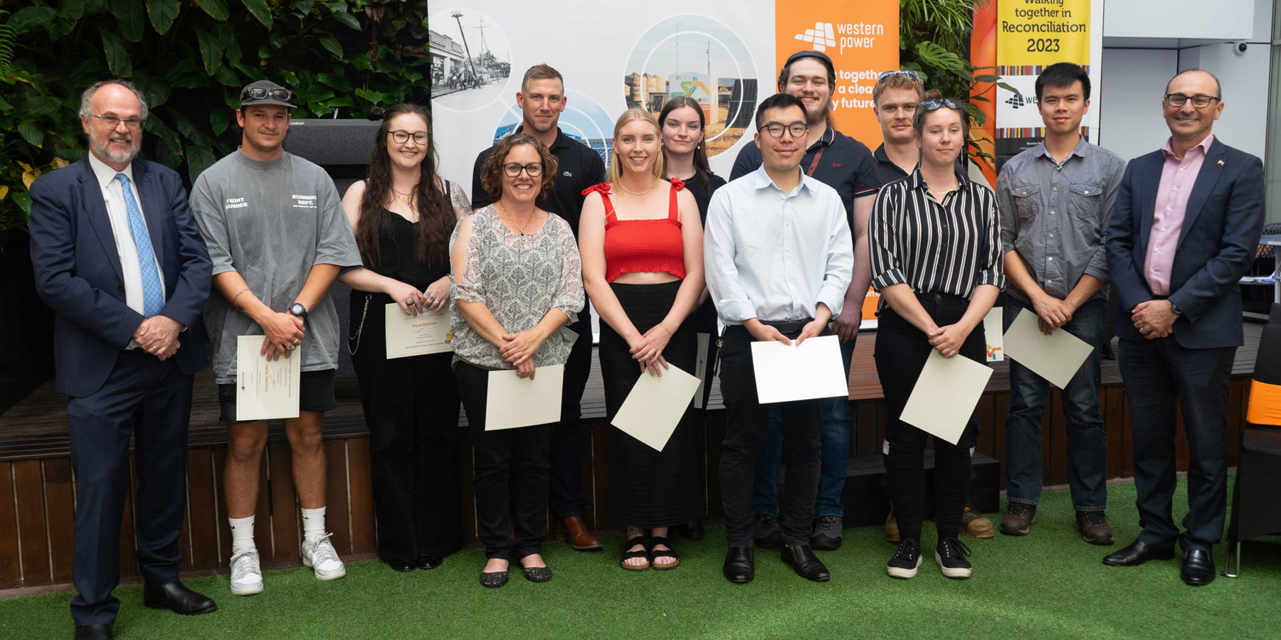 Business traineeship graduates and apprentices stood in a row alongside the Hon. Bill Johnston and Western Power CEO, Sam Barbaro